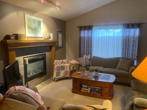 19 Prestwick Green Se, Calgary, AB - Indoor Photo Showing Living Room With Fireplace