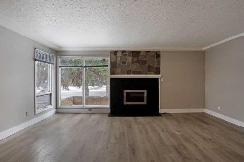 508 2 Avenue West, Brooks, AB - Indoor Photo Showing Living Room With Fireplace