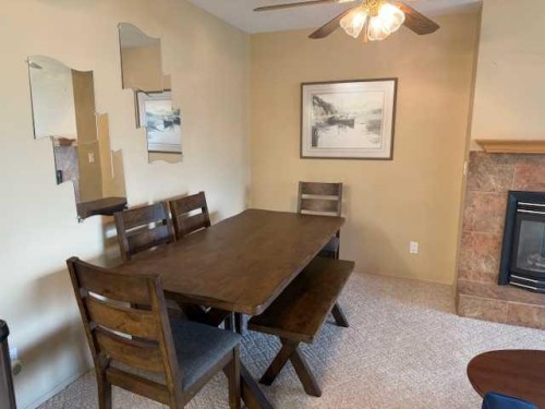 830 Birchwood Close, Drumheller, AB - Indoor Photo Showing Dining Room With Fireplace
