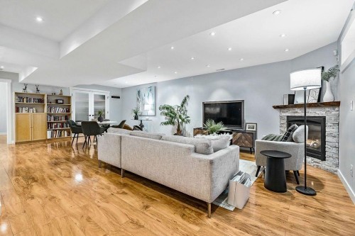 269 Windermere Road Sw, Calgary, AB - Indoor Photo Showing Living Room With Fireplace