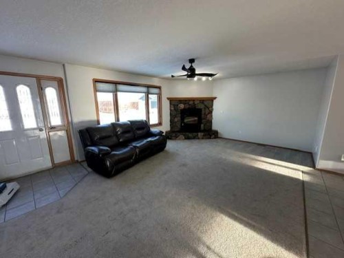 101 Wilkins Place, Hanna, AB - Indoor Photo Showing Living Room With Fireplace