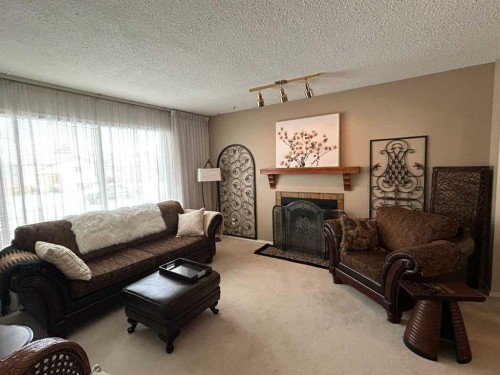 4529 Shannon Drive, Olds, AB - Indoor Photo Showing Living Room With Fireplace