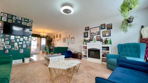 121 Shacker Crescent South, Hanna, AB - Indoor Photo Showing Living Room With Fireplace