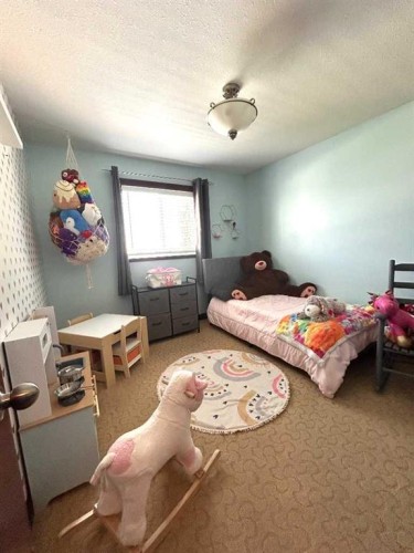 223 15 Street East, Brooks, AB - Indoor Photo Showing Bedroom