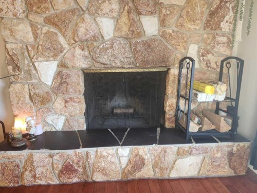 104 23 Street Nw, Drumheller, AB - Indoor Photo Showing Living Room With Fireplace