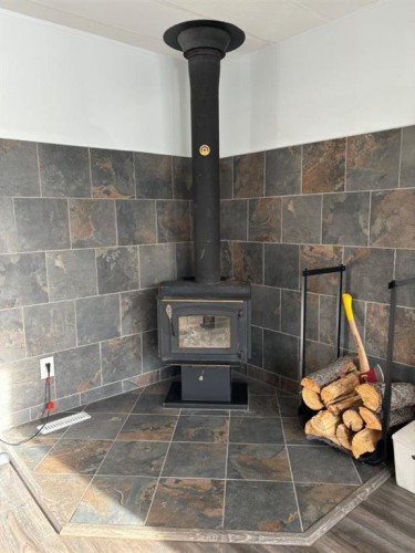 29 Southridge Crescent, Didsbury, AB - Indoor Photo Showing Other Room With Fireplace