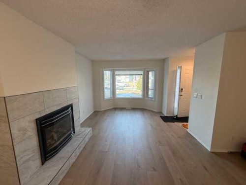 830 Birchwood Close, Drumheller, AB - Indoor Photo Showing Living Room With Fireplace