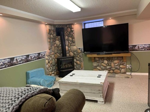 4617 51 Avenue, Taber, AB - Indoor Photo Showing Other Room With Fireplace