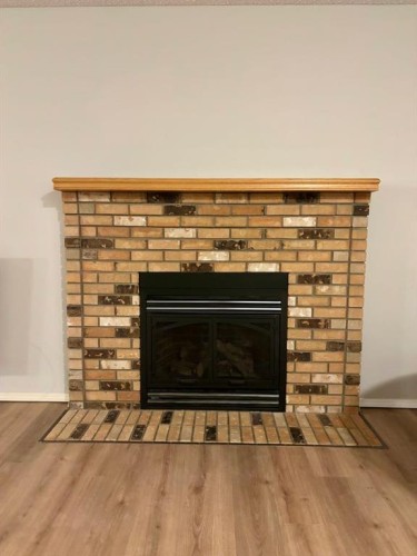 32 Ramsey Close, Red Deer, AB - Indoor Photo Showing Living Room With Fireplace