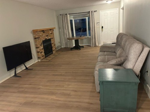 32 Ramsey Close, Red Deer, AB - Indoor Photo Showing Living Room With Fireplace