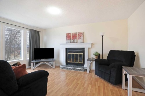 63 Ash Street West, Brooks, AB - Indoor Photo Showing Living Room With Fireplace