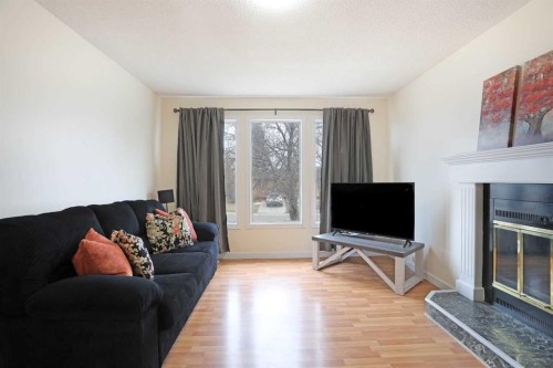 63 Ash Street West, Brooks, AB - Indoor Photo Showing Living Room With Fireplace