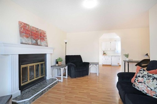 63 Ash Street West, Brooks, AB - Indoor Photo Showing Living Room With Fireplace