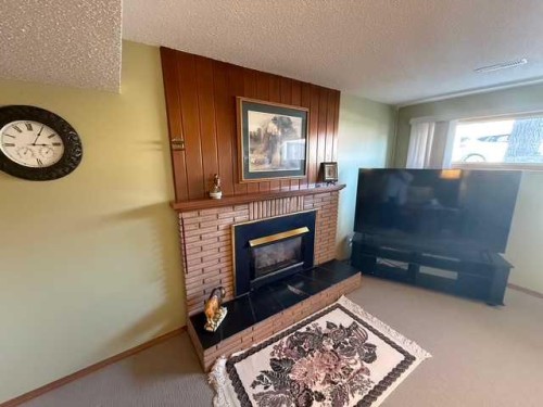 1023 2 Street Se, Drumheller, AB - Indoor Photo Showing Living Room With Fireplace