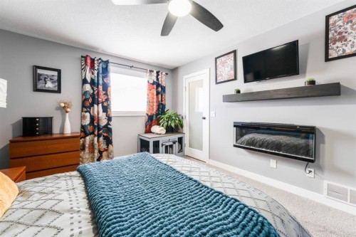 248 5 Street, Drumheller, AB - Indoor Photo Showing Bedroom With Fireplace