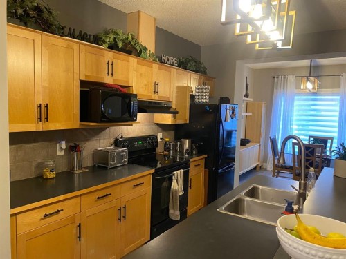 131 Bridlewood View Sw, Calgary, AB - Indoor Photo Showing Kitchen With Double Sink
