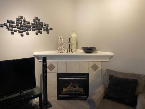 131 Bridlewood View Sw, Calgary, AB - Indoor Photo Showing Living Room With Fireplace