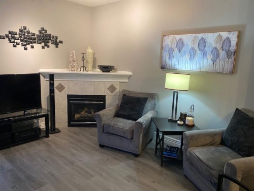 131 Bridlewood View Sw, Calgary, AB - Indoor Photo Showing Living Room With Fireplace