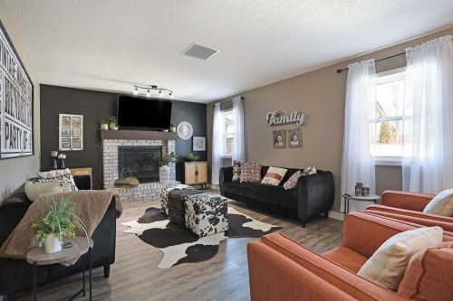 75 Parkland Close East, Brooks, AB - Indoor Photo Showing Living Room With Fireplace