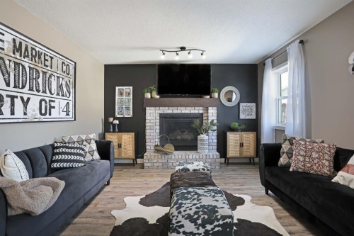 75 Parkland Close East, Brooks, AB - Indoor Photo Showing Living Room With Fireplace