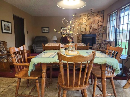 31 Larch Avenue, Drumheller, AB - Indoor Photo Showing Dining Room With Fireplace