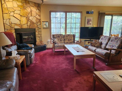 31 Larch Avenue, Drumheller, AB - Indoor Photo Showing Living Room With Fireplace