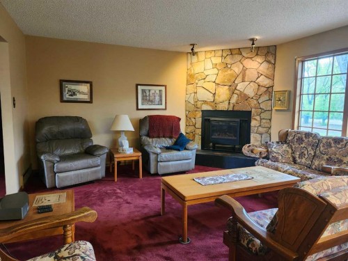 31 Larch Avenue, Drumheller, AB - Indoor Photo Showing Living Room With Fireplace