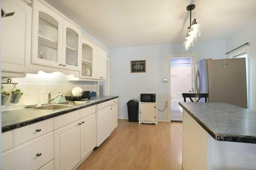320 3 Street West, Brooks, AB - Indoor Photo Showing Kitchen With Double Sink