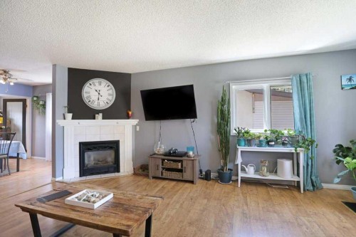 320 3 Street West, Brooks, AB - Indoor Photo Showing Living Room With Fireplace