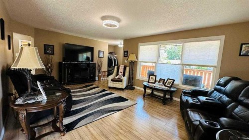 411 8 Street E, Drumheller, AB - Indoor Photo Showing Living Room With Fireplace
