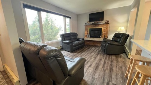 303 Nill Place, Hanna, AB - Indoor Photo Showing Living Room With Fireplace