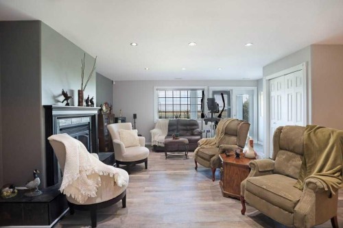 96 Greystone Close East, Brooks, AB - Indoor Photo Showing Living Room With Fireplace