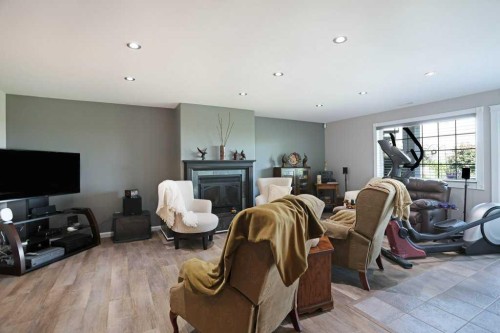 96 Greystone Close East, Brooks, AB - Indoor Photo Showing Other Room With Fireplace