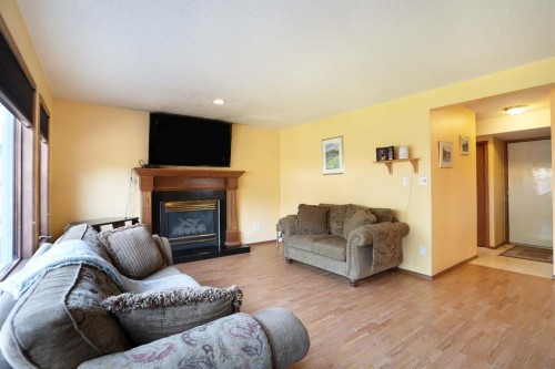 35 Parkland Close East, Brooks, AB - Indoor Photo Showing Living Room With Fireplace