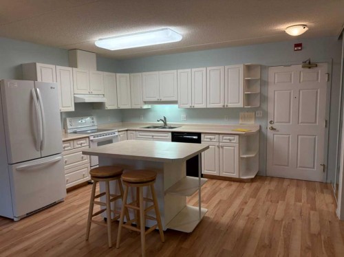 209-4514 54 Avenue, Olds, AB - Indoor Photo Showing Kitchen With Double Sink