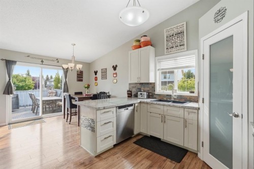 76 Crystalridge Crescent, Okotoks, AB - Indoor Photo Showing Kitchen With Double Sink