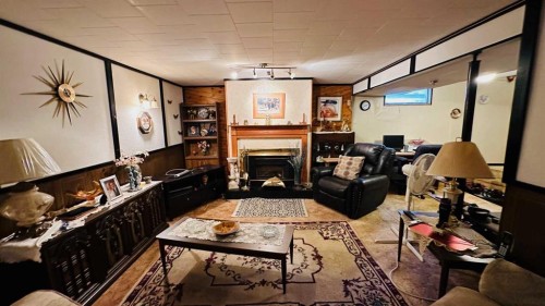 44 Cedar Crescent, Drumheller, AB - Indoor Photo Showing Other Room With Fireplace
