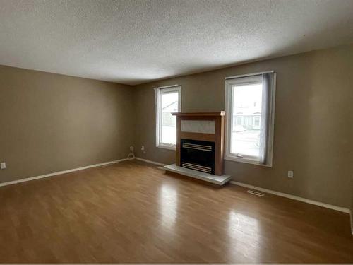 1025 6 Avenue, Wainwright, AB - Indoor Photo Showing Living Room With Fireplace