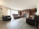 4900 2Nd Avenue North, Chauvin, AB  - Indoor Photo Showing Living Room With Fireplace 