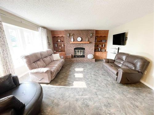 4900 2Nd Avenue North, Chauvin, AB - Indoor Photo Showing Living Room With Fireplace