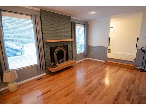 402 3 Street, Wainwright, AB - Indoor Photo Showing Living Room With Fireplace