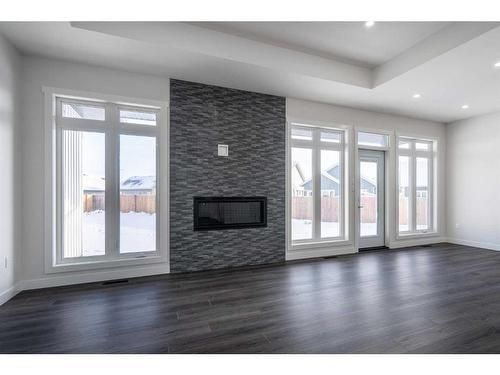 7302 37 Street Close, Lloydminster, AB - Indoor Photo Showing Living Room With Fireplace
