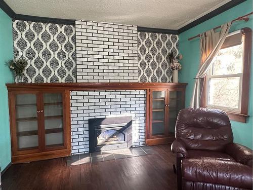 4716 52 Avenue, Vermilion, AB - Indoor Photo Showing Other Room With Fireplace