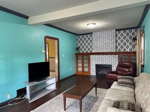 4716 52 Avenue, Vermilion, AB - Indoor Photo Showing Living Room With Fireplace