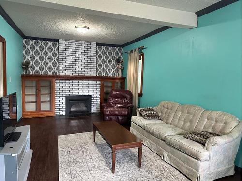 4716 52 Avenue, Vermilion, AB - Indoor Photo Showing Living Room With Fireplace