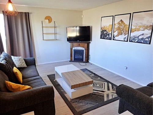 4702 52 Avenue, Vermilion, AB - Indoor Photo Showing Living Room With Fireplace