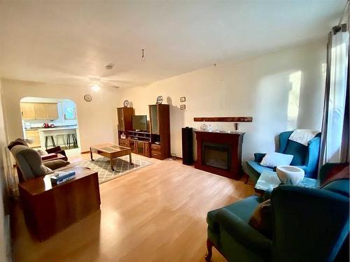 5206 2 Avenue North, Chauvin, AB - Indoor Photo Showing Living Room With Fireplace