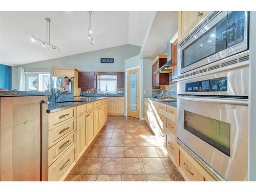 35 Harrier Lane, Rural Vermilion River, County Of, AB - Indoor Photo Showing Kitchen With Fireplace