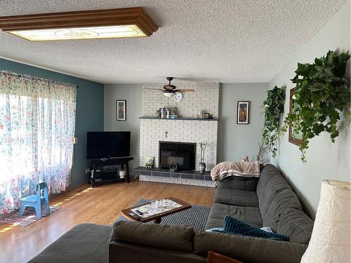 4803 47 Street, Hardisty, AB - Indoor Photo Showing Living Room With Fireplace