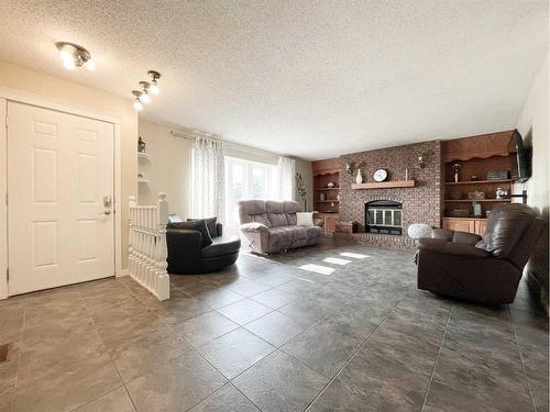 4900 2Nd Avenue North, Chauvin, AB - Indoor Photo Showing Living Room With Fireplace